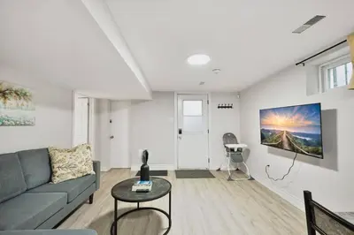a living room with a couch and a table at Comfy 2BR Apt near Beach and Downtown Free Parking in Oshawa