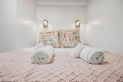 a bedroom with a bed with towels on it at Comfy 2BR Apt near Beach and Downtown Free Parking in Oshawa