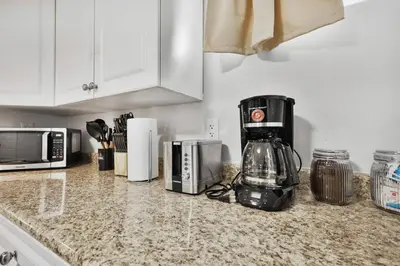 a kitchen counter with a blender and a microwave at Comfy 2BR Apt near Beach and Downtown Free Parking in Oshawa