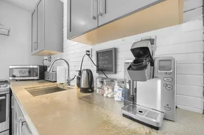 a kitchen with a sink and a coffee maker at 2BR Downtown Retreat Mins to Beach BBQ and Firepit in Cobourg