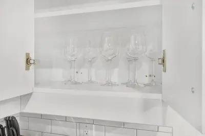 a row of wine glasses sitting on a shelf at 3BR Pickering Retreat with BBQ and Patio Delight in Pickering