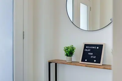 a mirror on a wall above a table with a chalkboard at Stylish 3BDR in Pickering Heart Free Parking in Pickering