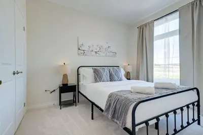a white bedroom with a bed and a window at Stylish 3BDR in Pickering Heart Free Parking in Pickering