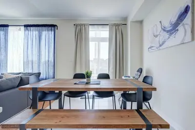 a living room with a wooden table and chairs at Stylish 3BDR in Pickering Heart Free Parking in Pickering