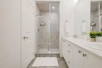 a white bathroom with a shower and a sink at Stylish 3BDR in Pickering Heart Free Parking in Pickering