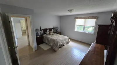 a bedroom with a bed and a window at Spacious, Peaceful & Perfectly Located - 4BR,3BA in London