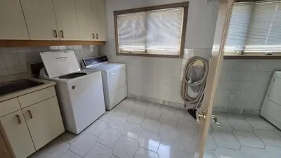 a small kitchen with a washing machine and a washer at Spacious, Peaceful & Perfectly Located - 4BR,3BA in London