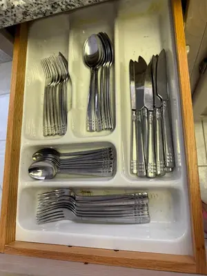 a drawer filled with silver utensils in a cabinet at Spacious, Peaceful & Perfectly Located - 4BR,3BA in London
