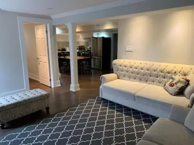 a living room with a white couch and a rug at Basement apartment in Vaughan