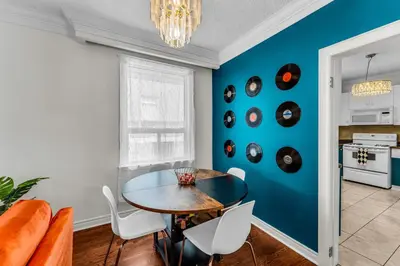 a dining room with a table and a blue wall at 80's Retro Toronto Time Capsule - 2 Bedrooms in Toronto