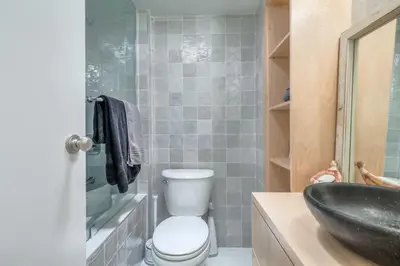 a bathroom with a toilet and a sink at Cozy 2BR Home with Workspaces, Fireplace and Parking in Toronto