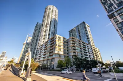two tall buildings in a city with a street at Downtown Urban Oasis I Entertainment District in Toronto
