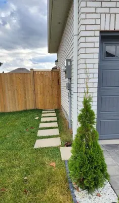 a yard with a blue door and a fence at Gracy's property in Thamesford