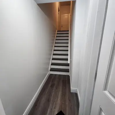 a hallway with a staircase with a stair case at Gracy's property in Thamesford