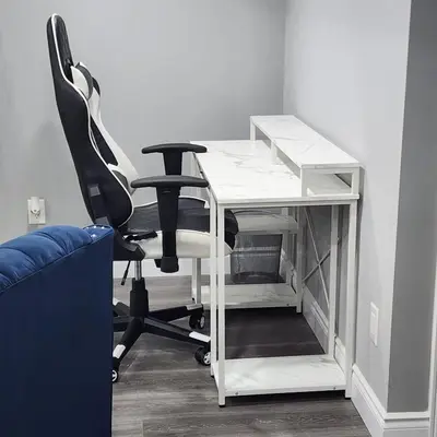 a white desk with a black chair next to a couch at Gracy's property in Thamesford
