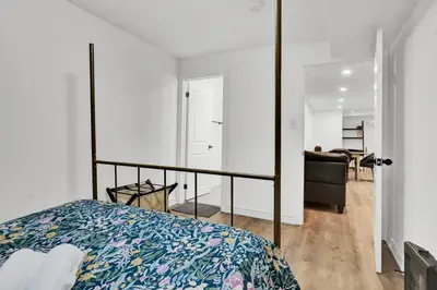 a bedroom with a bed and a mirror at 5mins Shopping, Stylish Modern 2BR Kitchen Suite in Markham in Markham