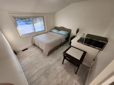 a small bedroom with a bed and a desk at 3Q Ltd in Hamilton