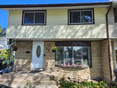 a house with two windows and a white door at 3Q Ltd in Hamilton