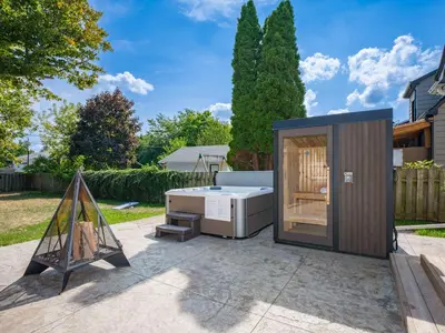 a tiny house with a hot tub in a yard at Outdoor Sauna Hot Tub Playroom Port Dallhousie in St. Catharines