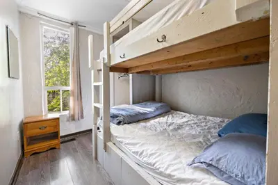 a bedroom with two bunk beds and a window at Margaritaville - Big Space with Lots of fun and Hot Tub 38R in Blue Mountains