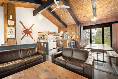 a living room with leather couches and a table at Margaritaville - Big Space with Lots of fun and Hot Tub 38R in Blue Mountains