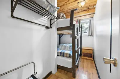 a bedroom with a bunk bed in a tiny house at Margaritaville - Big Space with Lots of fun and Hot Tub 38R in Blue Mountains