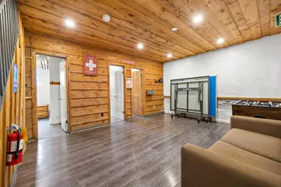 a living room with a couch and a flat screen tv at Margaritaville - Big Space with Lots of fun and Hot Tub 38R in Blue Mountains