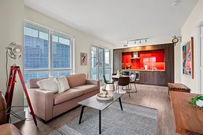 a living room with a couch and a table at Luxury 2 Bedroom CN Tower View in Toronto