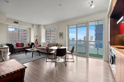 a living room with a couch and a table at Luxury 2 Bedroom CN Tower View in Toronto