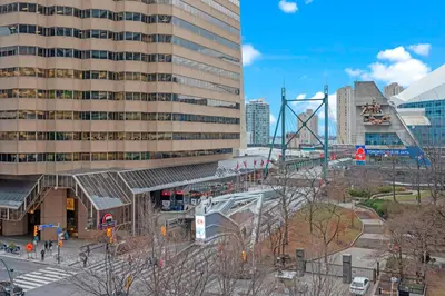 a train station in a city with a building at Classy 1-Bedroom & Den Condo in Heart of Downtown in Toronto