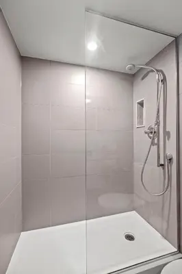 a shower with a glass door in a bathroom at Classy 1-Bedroom & Den Condo in Heart of Downtown in Toronto