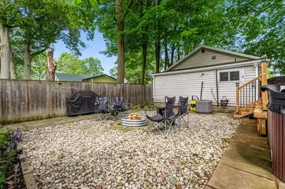 a backyard with chairs and a table and a fence at Crystal Tides Retreat in Fort Erie