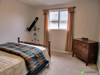 a bedroom with a camera on a tripod next to a bed at HB Guest Home in Waterloo