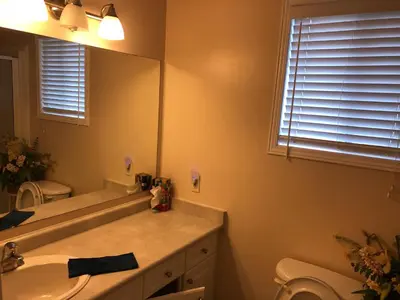 a bathroom with a sink and a mirror and a toilet at HB Guest Home in Waterloo