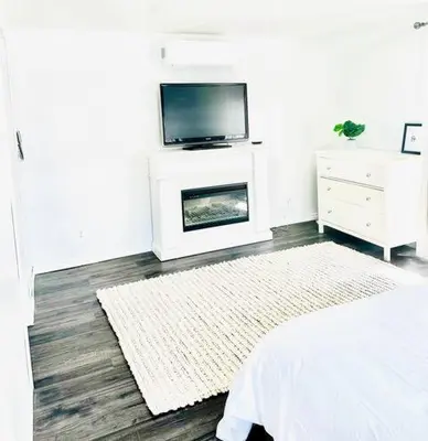 a living room with a television and a fireplace at Our Happy Place in Wilberforce