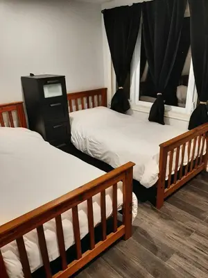 a bedroom with two beds and two windows at Our Happy Place in Wilberforce