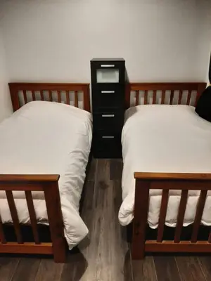 a bedroom with two twin beds and a dresser at Our Happy Place in Wilberforce