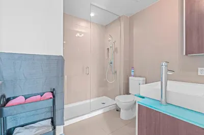 a bathroom with a shower and a toilet and a sink at 1-Bedroom & Den condo Bird's Eye View in DT in Toronto