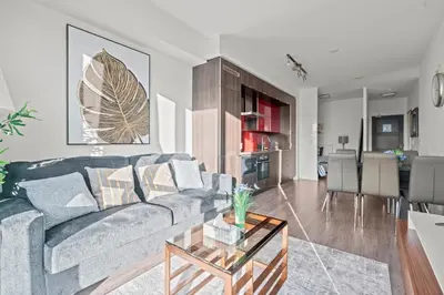 a living room with a couch and a table at 1-Bedroom & Den condo Bird's Eye View in DT in Toronto