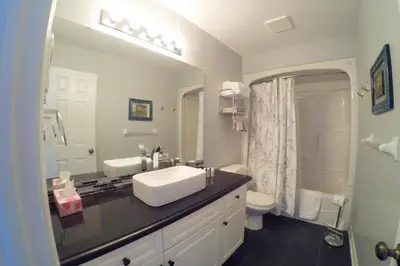 a bathroom with a sink and a toilet and a mirror at Blue Skies Bed & Breakfast in Niagara on the Lake