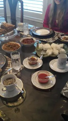 a table with plates and bowls of food on it at Blue Skies Bed & Breakfast in Niagara on the Lake