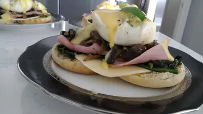 a plate with two sandwiches with meat and cheese at Blue Skies Bed & Breakfast in Niagara on the Lake