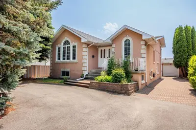 a house with a driveway in front of it at The Wilcox Villa in Mississauga