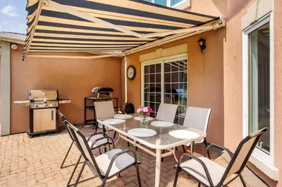 a patio with a table and chairs and a grill at The Wilcox Villa in Mississauga