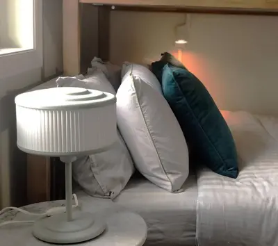 a bedroom with a bed with pillows and a lamp at Stylish 2bed, 2bth Apt Malls & 25 Mins to Toronto in Mississauga