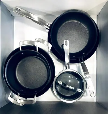 two frying pans sitting on top of a stove at Stylish 2bed, 2bth Apt Malls & 25 Mins to Toronto in Mississauga