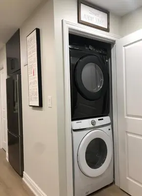 a washer and dryer in a kitchen next to a wall at Stylish 2bed, 2bth Apt Malls & 25 Mins to Toronto in Mississauga