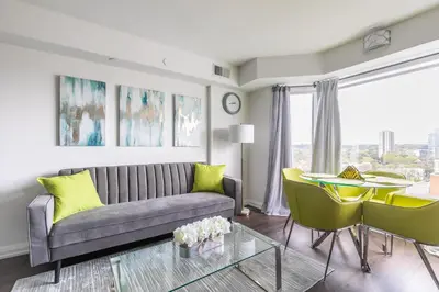 a living room with a couch and a table at Forest 1Bd & DEN in Yorkville 10 Floor in Toronto