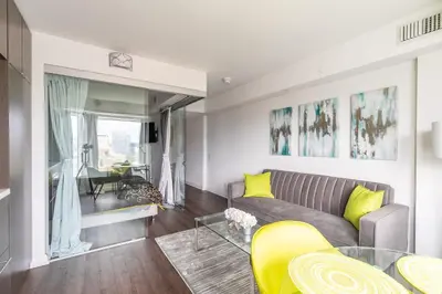 a living room with a couch and a table at Forest 1Bd & DEN in Yorkville 10 Floor in Toronto