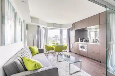 a living room with a couch and a table at Forest 1Bd & DEN in Yorkville 10 Floor in Toronto
